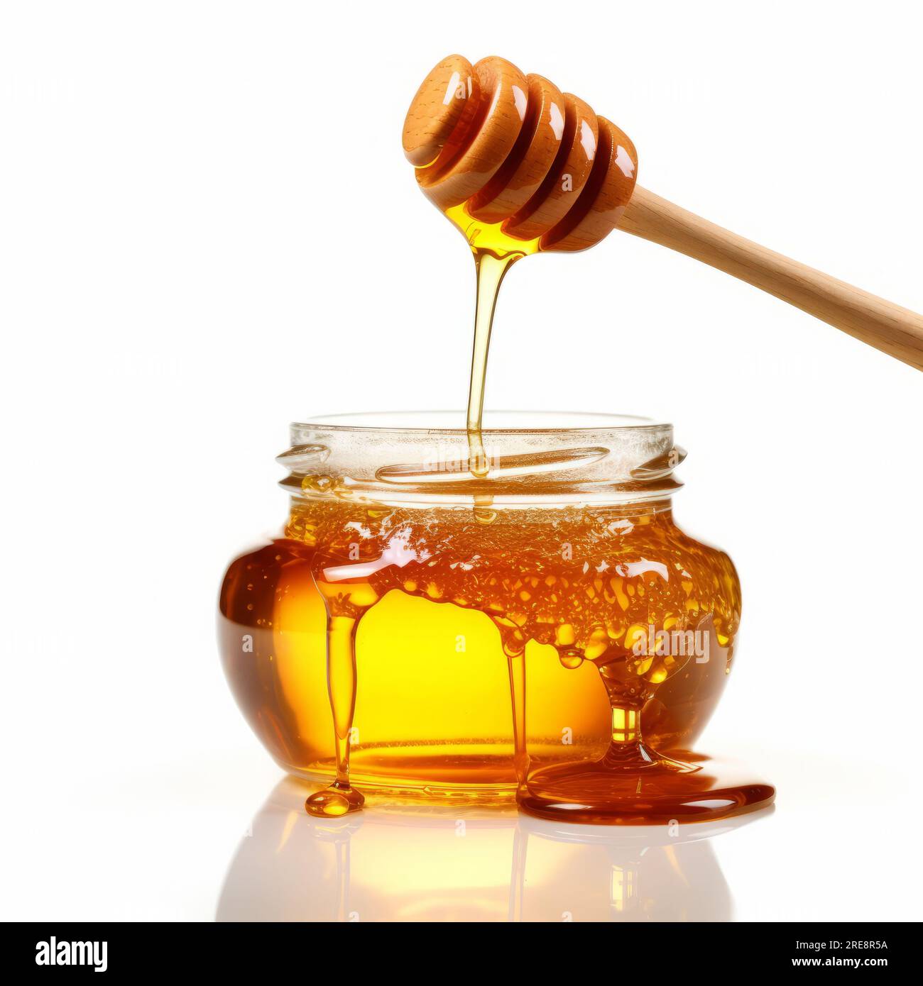 Honey in jar and and wooden stick isolated on white background Stock