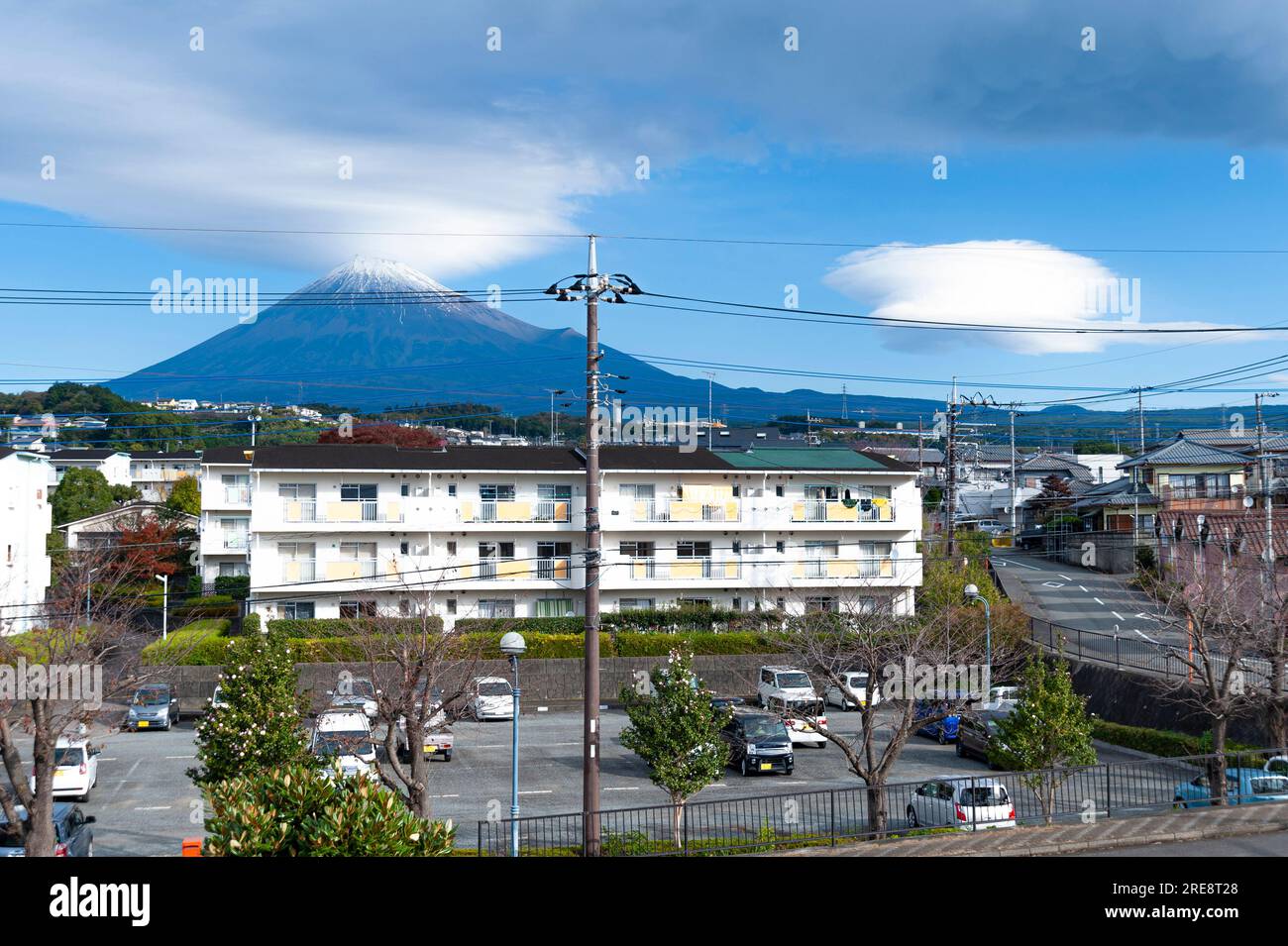Fuji City, Shizuoka Prefecture, Japan - November 14, 2021: Beautiful city scene of Mount Fuji with housing estate, cars and houses with clouds and blu Stock Photo