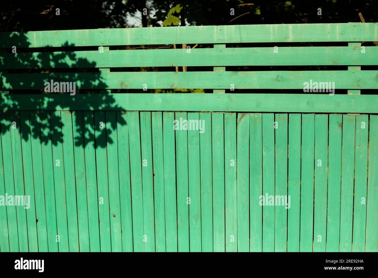 Wooden fence. Green board. Fencing in rural areas. Details of construction. Stock Photo