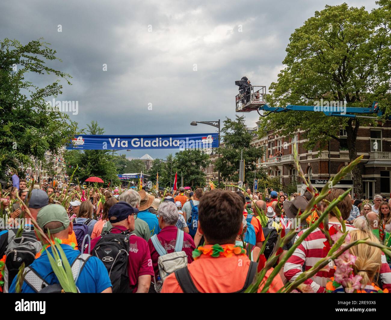 July 21, 2023, Nijmegen, Netherlands: Walkers are seen arriving at the street called for this event ''Via Gladiola''. Since it is the worldâ€™s biggest multi-day walking event, The International Four Days Marches (in Dutch 'De Vierdaagse') is seen as the prime example of sportsmanship and international bonding between military servicemen, women and civilians from many different countries. This year, it was the 105 edition and the official amount of walkers registered was 43,363 from 77 countries. Participants can choose to walk 30km, 40km, or 50km per day. On the last day, 39,019 walkers cross Stock Photo