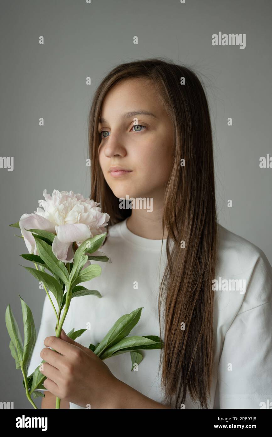 Portrait of side view of dreamy preteen girl child with long hair ...