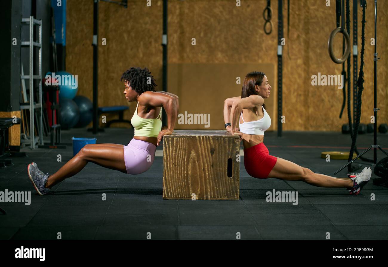 Full body side view of fit multiracial female athletes in