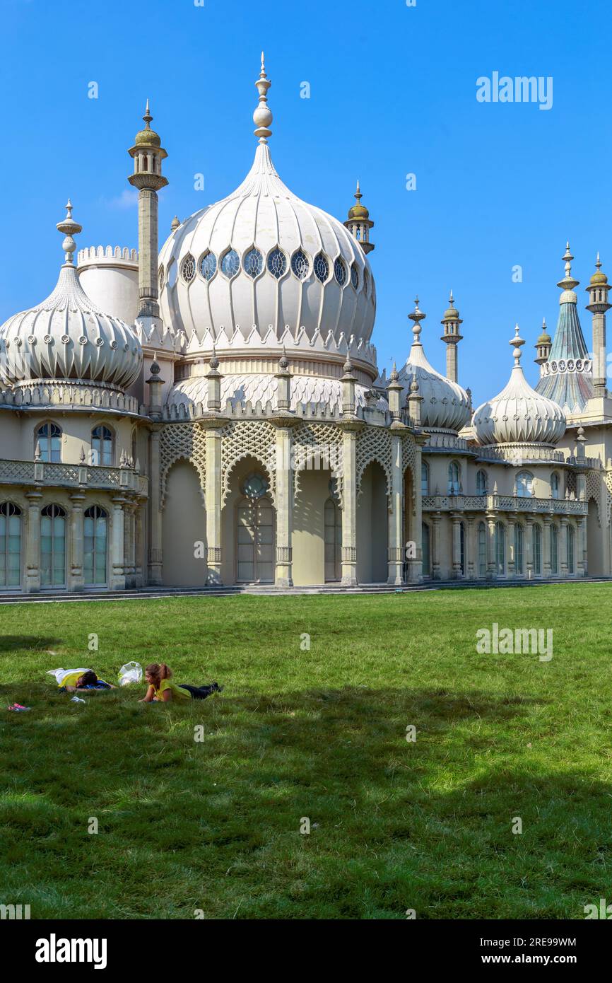 BRIGHTON, GREAT BRITAIN - SEPTEMBER 16, 2014: This is a fragment of the lawn in front of the Royal Pavilion with people resting on the grass. Stock Photo