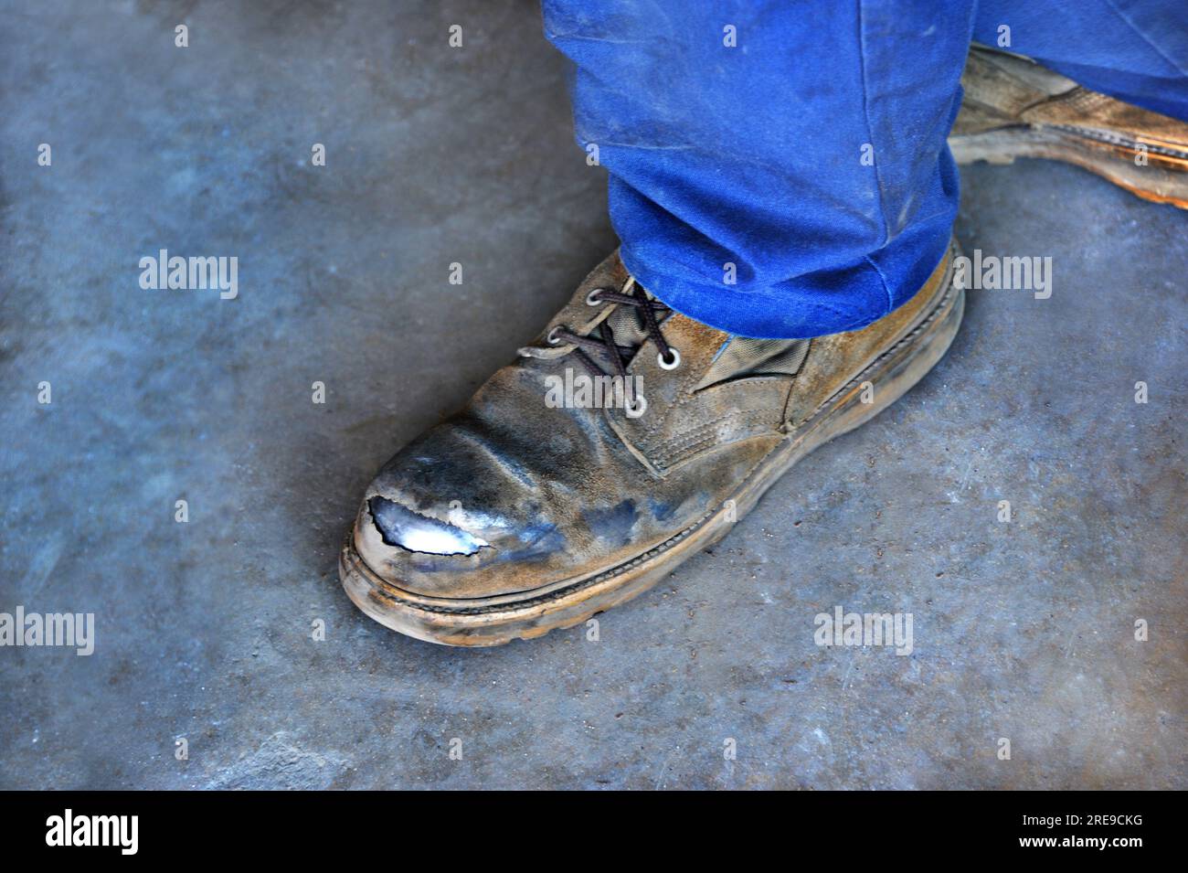 Worker is wearing a well broken in pair of boots. The steel plate is