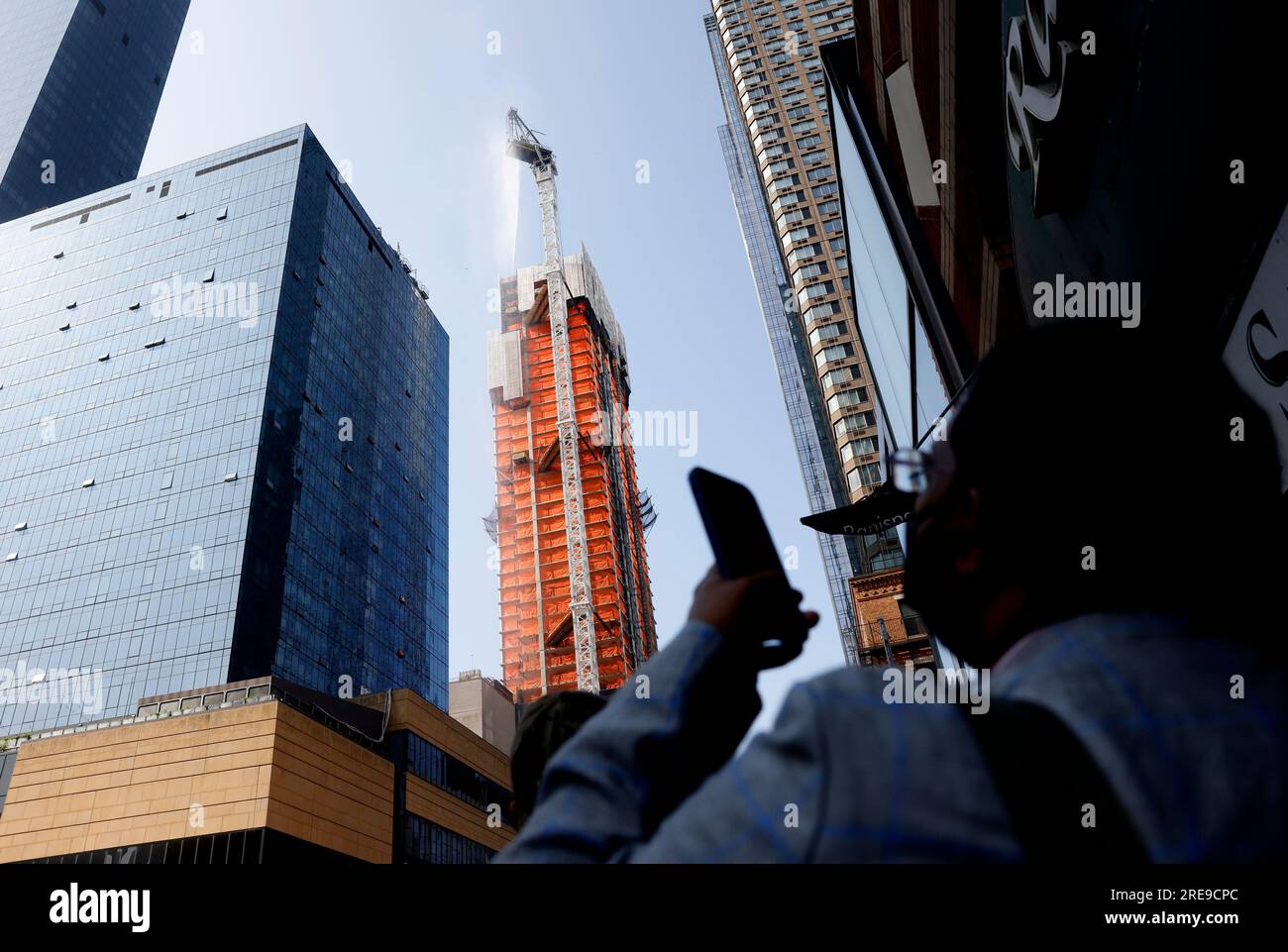 New York, United States. 26th July, 2023. FDNY workers put water on a crane after it partially collapses in New York City on Wednesday, July 26, 2023. A large crane on a high-rise building caught fire and partially collapsed in Manhattan on Wednesday morning causing debris to fall to the ground with five injuries reported. Photo by John Angelillo/UPI Credit: UPI/Alamy Live News Stock Photo