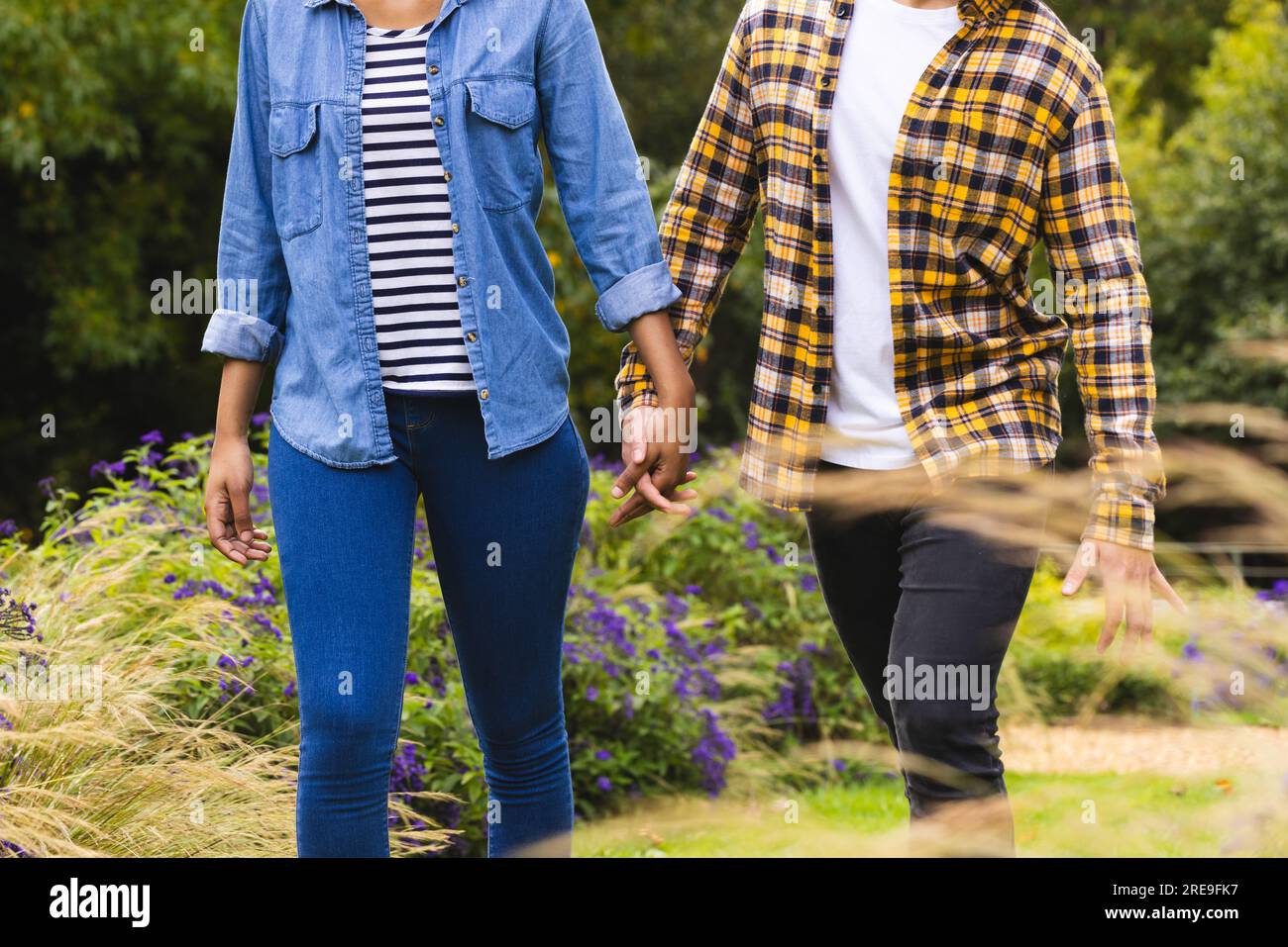 Diverse couple holding hands walking hi-res stock photography and ...