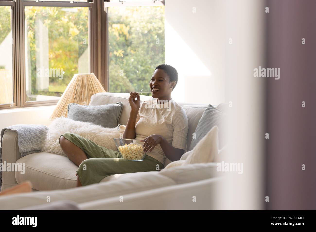 Woman happy watching tv hi-res stock photography and images - Alamy