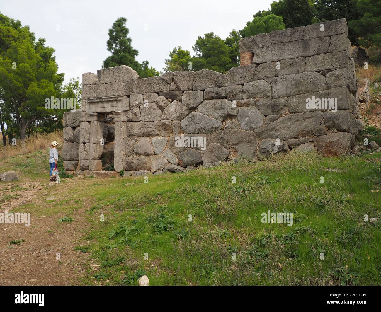 Temple of Diana, Cefalu, Sicily.  Exterior with single figure at the megalithic entrance. Stock Photo