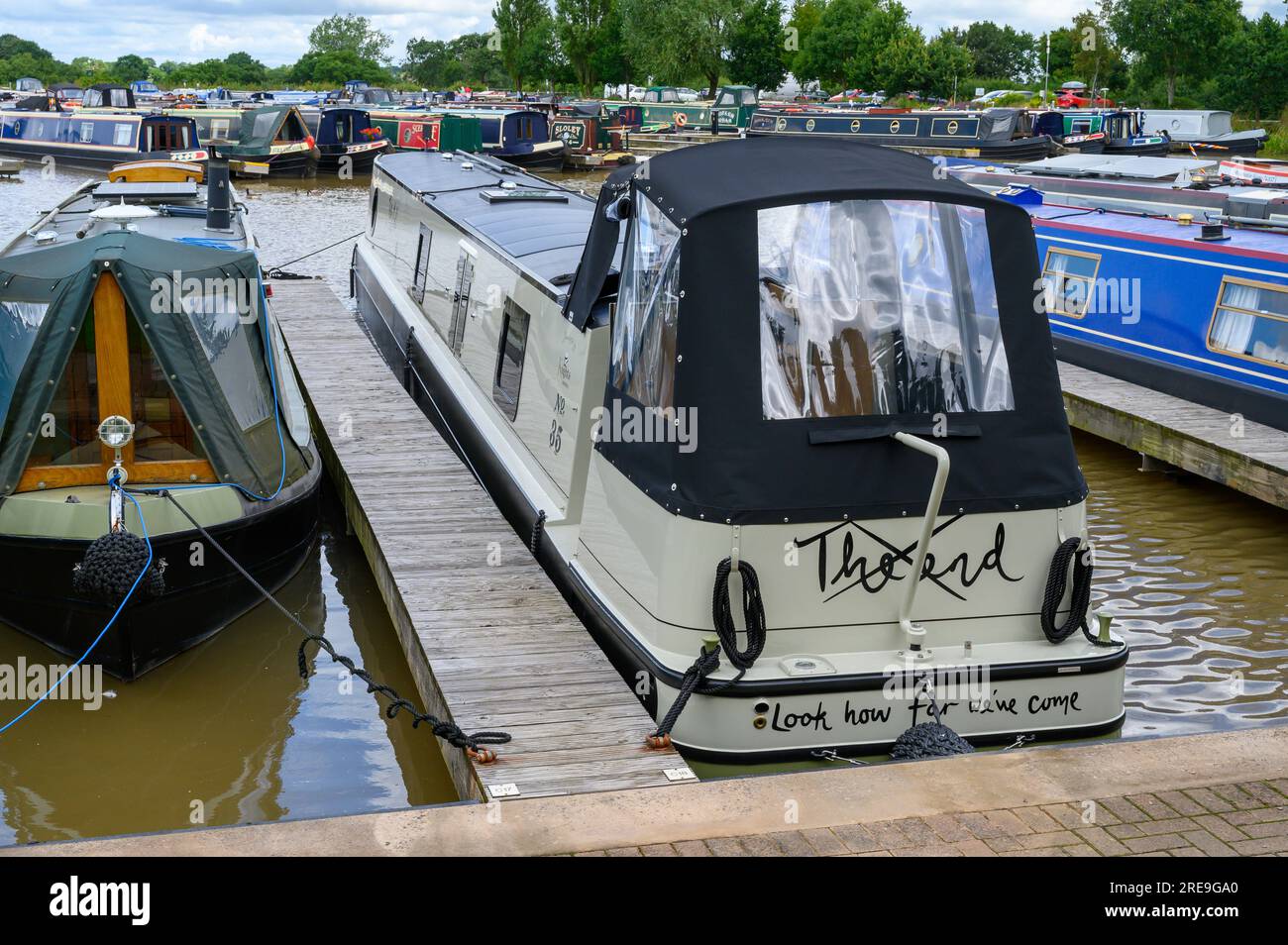 New narrowboat called The Mole on its moorings in a marina. The boat is named after the book The Boy, the Mole, the Fox and the Horse by Charlie Macke Stock Photo