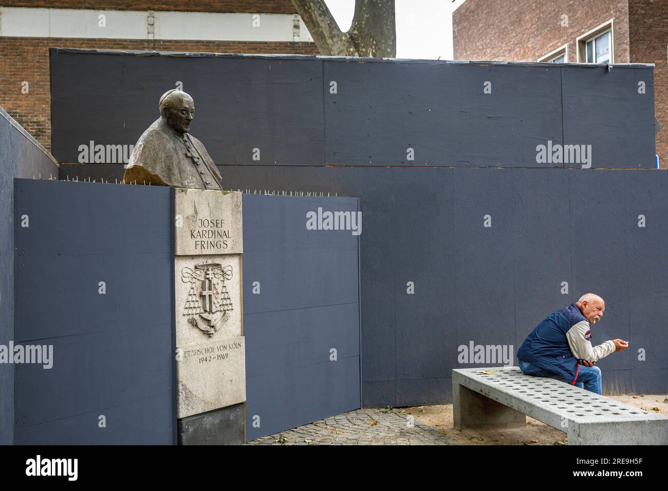 monument for Josef Kardinal Frings, Archbishop of Cologne from 1942 to 1969 on the Laurenz square, temporarily enclosed by a construction fence, Colog Stock Photo