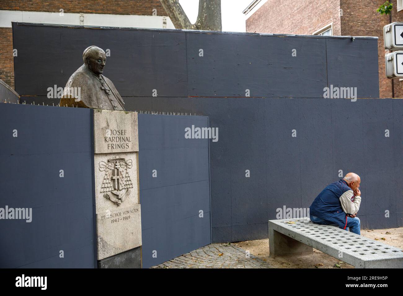 monument for Josef Kardinal Frings, Archbishop of Cologne from 1942 to 1969 on the Laurenz square, temporarily enclosed by a construction fence, Colog Stock Photo