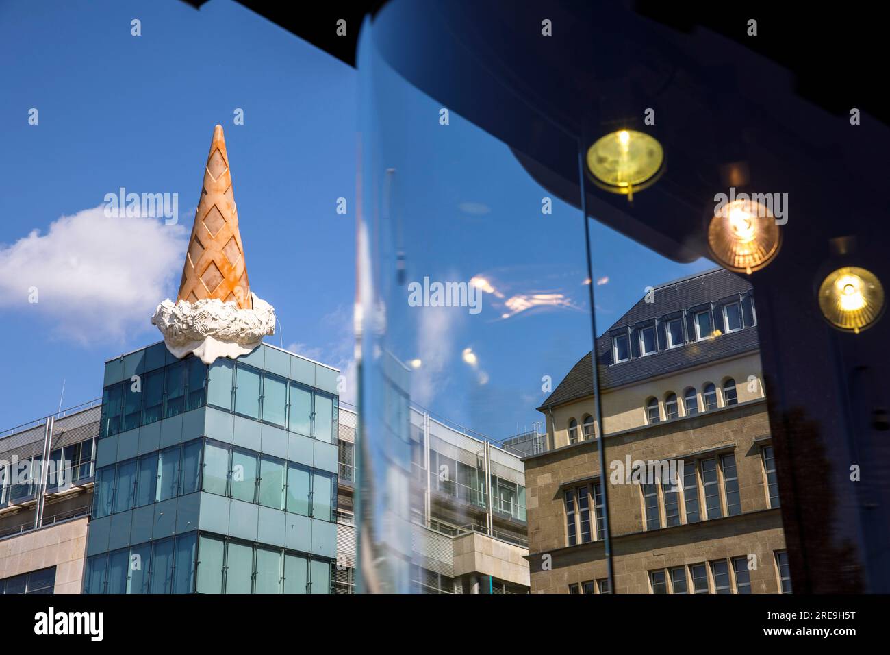 ice-cream cone by Popart artist Claes Oldenburg on top of the shopping mall Neumarkt Galerie, shop window, Cologne, Germany. Eistuete des Popart-Kuens Stock Photo