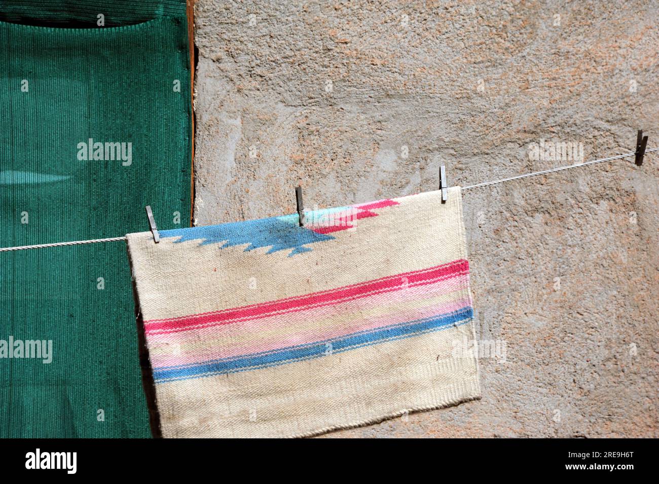 Adobe home uses the old fashioned way to dry clothes, on a clothesline