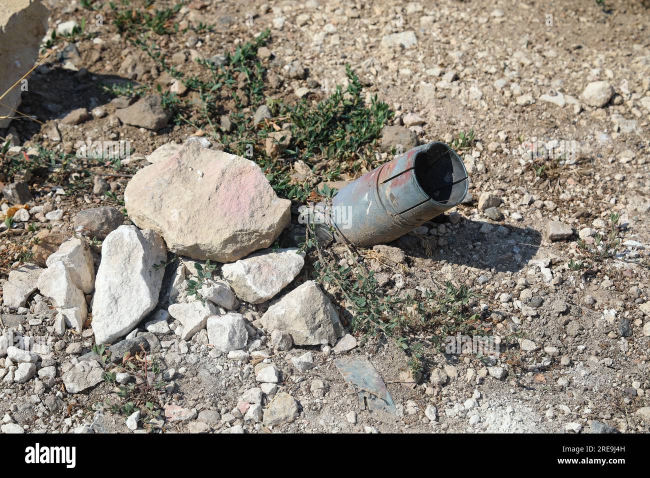 BLAHODATNE, UKRAINE - JULY 19, 2023 - A fragment of a shell is stuck in the ground in Blahodatne village which was destroyed by Russian occupiers, Myk Stock Photo