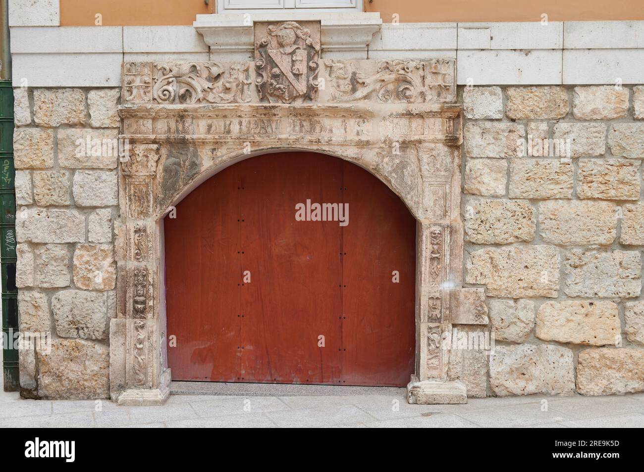 Ancient facade with red wooden door Stock Photo - Alamy
