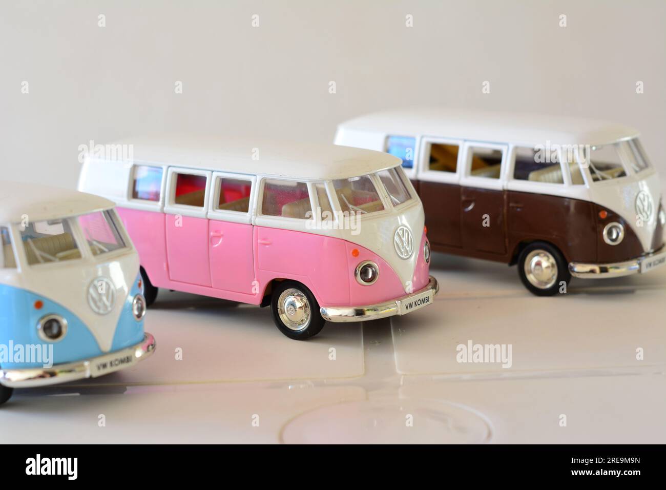 Iron miniature, Diecast, various color vans, Brazil, South America, side view, selective focus, white background, red color, intentional blur Stock Photo