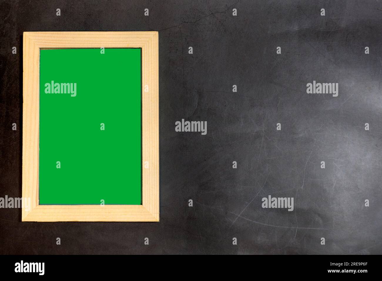 wooden photo frame inside in green screen on dark background. copy space for text and pictures. Stock Photo