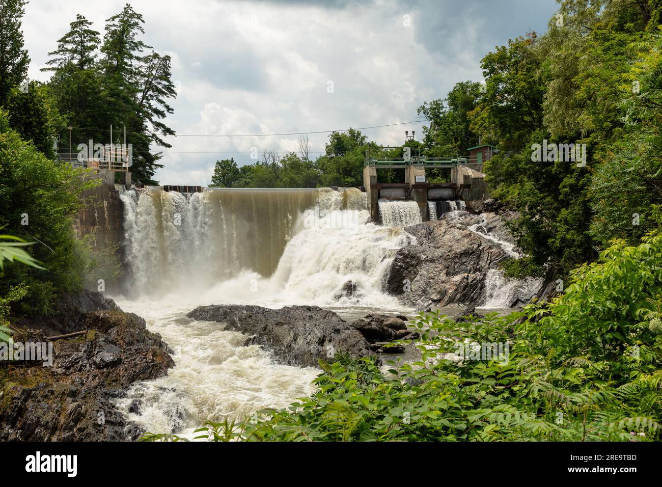 The Waits River Falls are seen in the quaint town of Bradford, Vermont. The waterfall is formed by a dam along the Waits River, a tributary of the Con Stock Photo