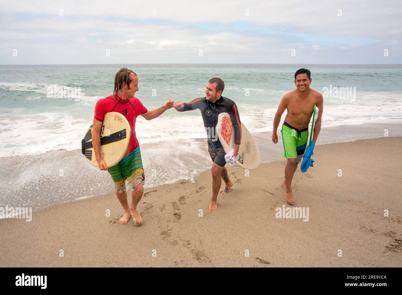 Laguna Beach, California, USA. 20th Aug, 2017. Multiracial surfers share fish bump congratulations after a skimboard competition in Laguna Beach, CA. (Credit Image: © Spencer Grant/ZUMA Press Wire) EDITORIAL USAGE ONLY! Not for Commercial USAGE! Stock Photo