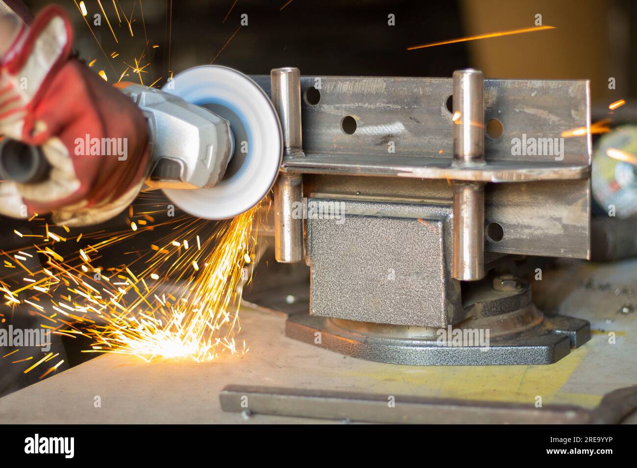 Steel trimming. Sparks from scraping metal. Grinder work. Creation of