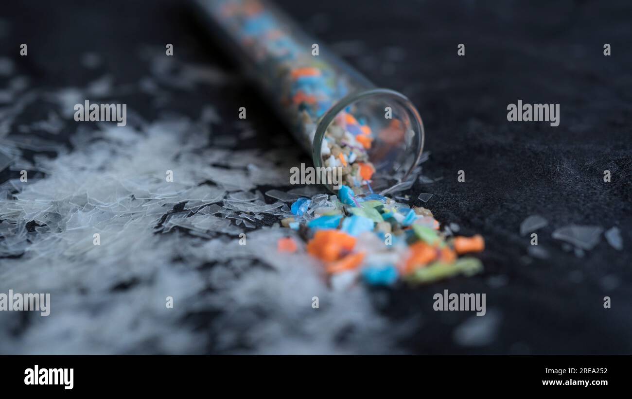 Macro shot of a test tube full of micro plastics collected from the beach. Concept of water pollution and industrial waste management. Stock Photo