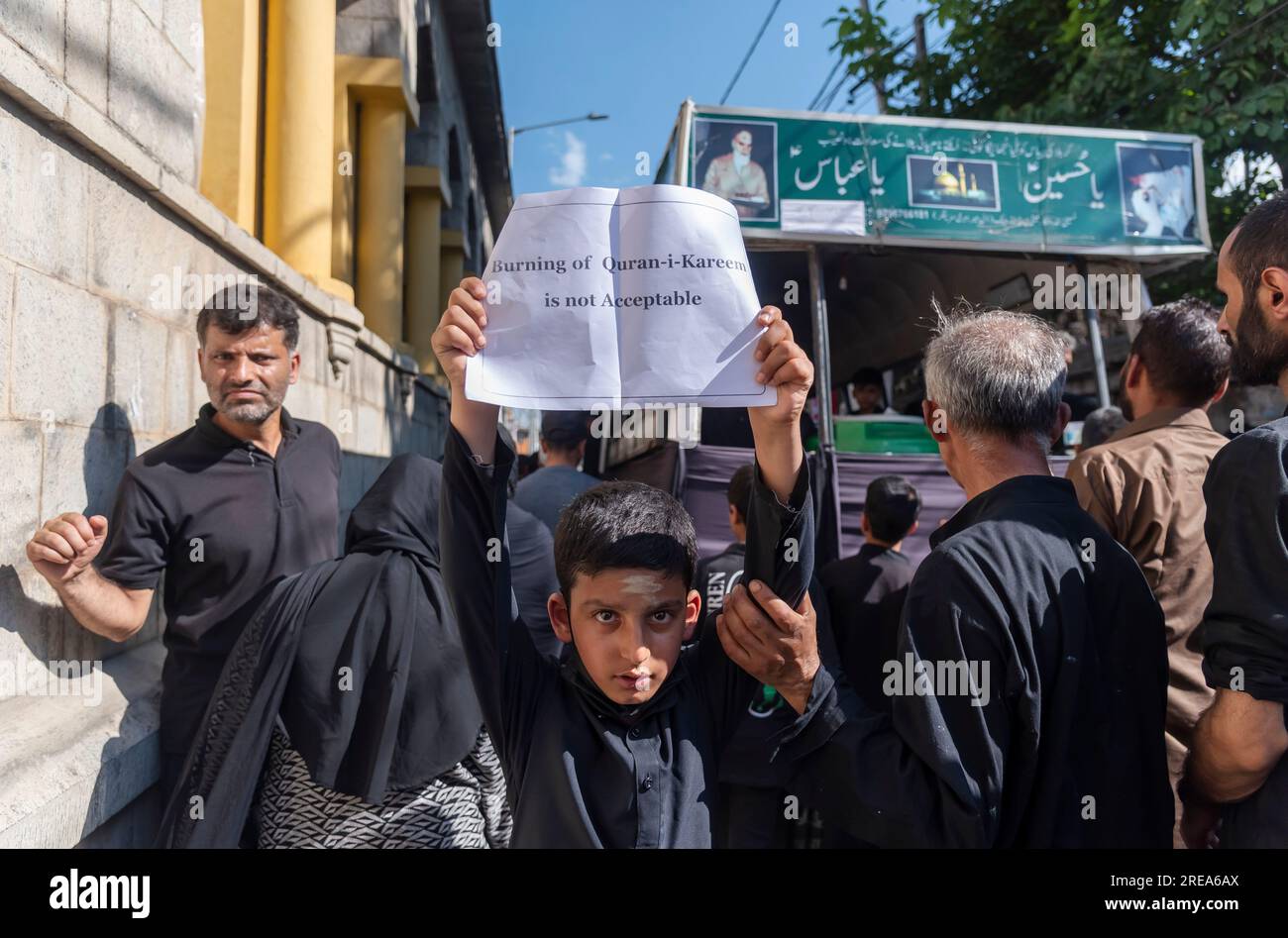 Srinagar, India. 26th July, 2023. A Kashmiri Shia Muslim boy hold a ...