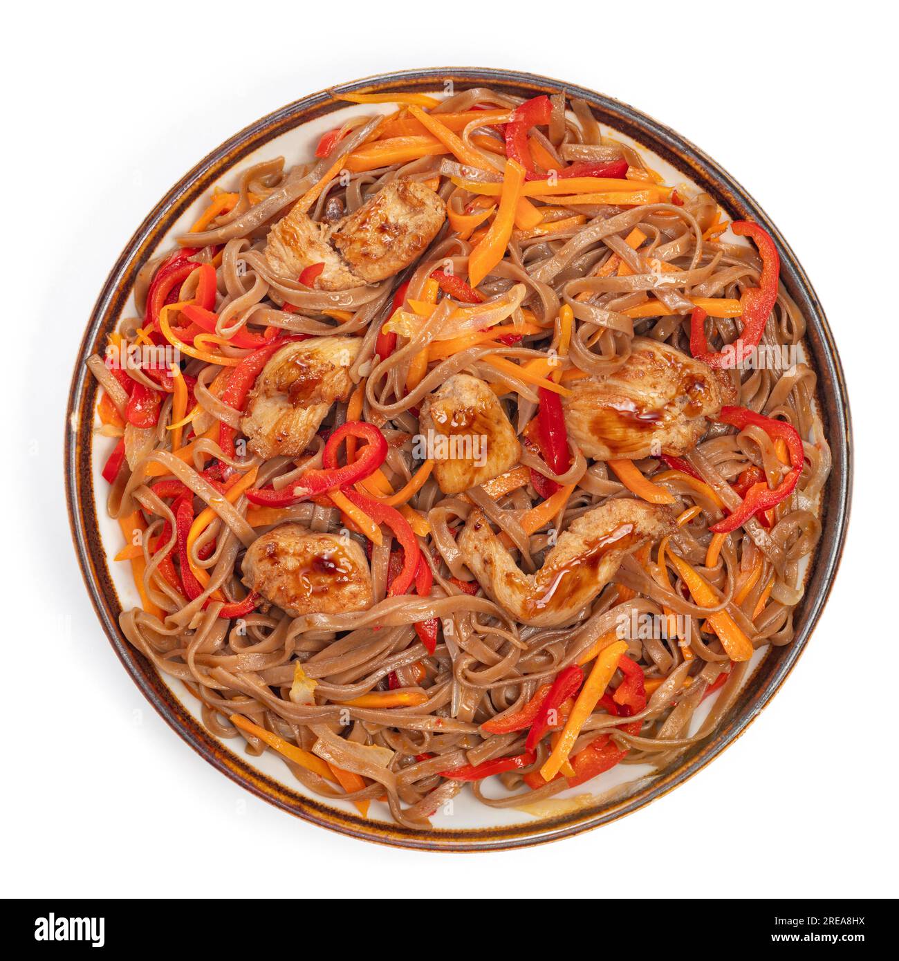 Asian fried buckwheat noodles with chicken and vegetables isolated on