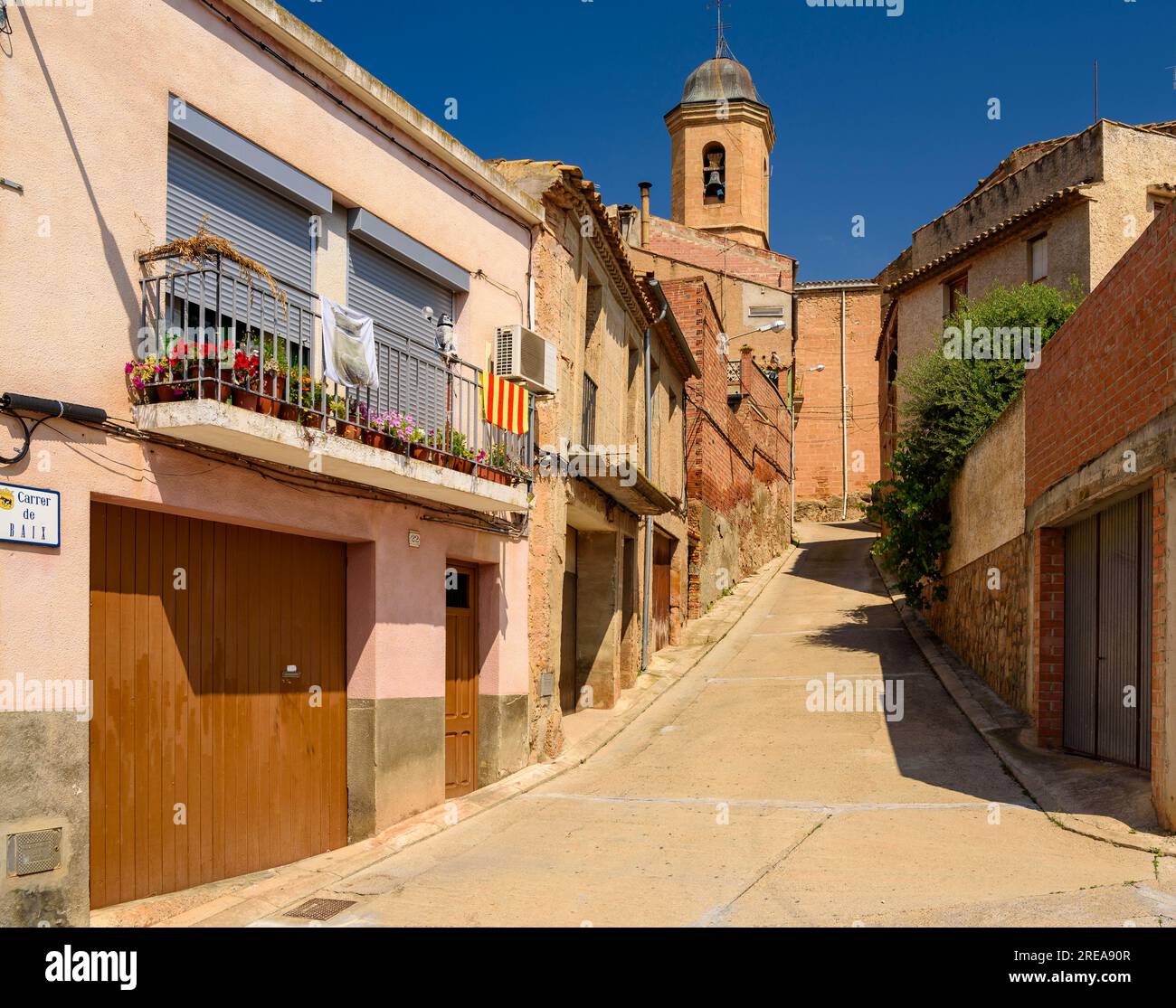 Street and church of Saint Joseph, in Bovera, on a spring morning (Les Garrigues, Lleida, Catalonia, Spain) ESP: Calle e iglesia de Bovera (Lérida) Stock Photo