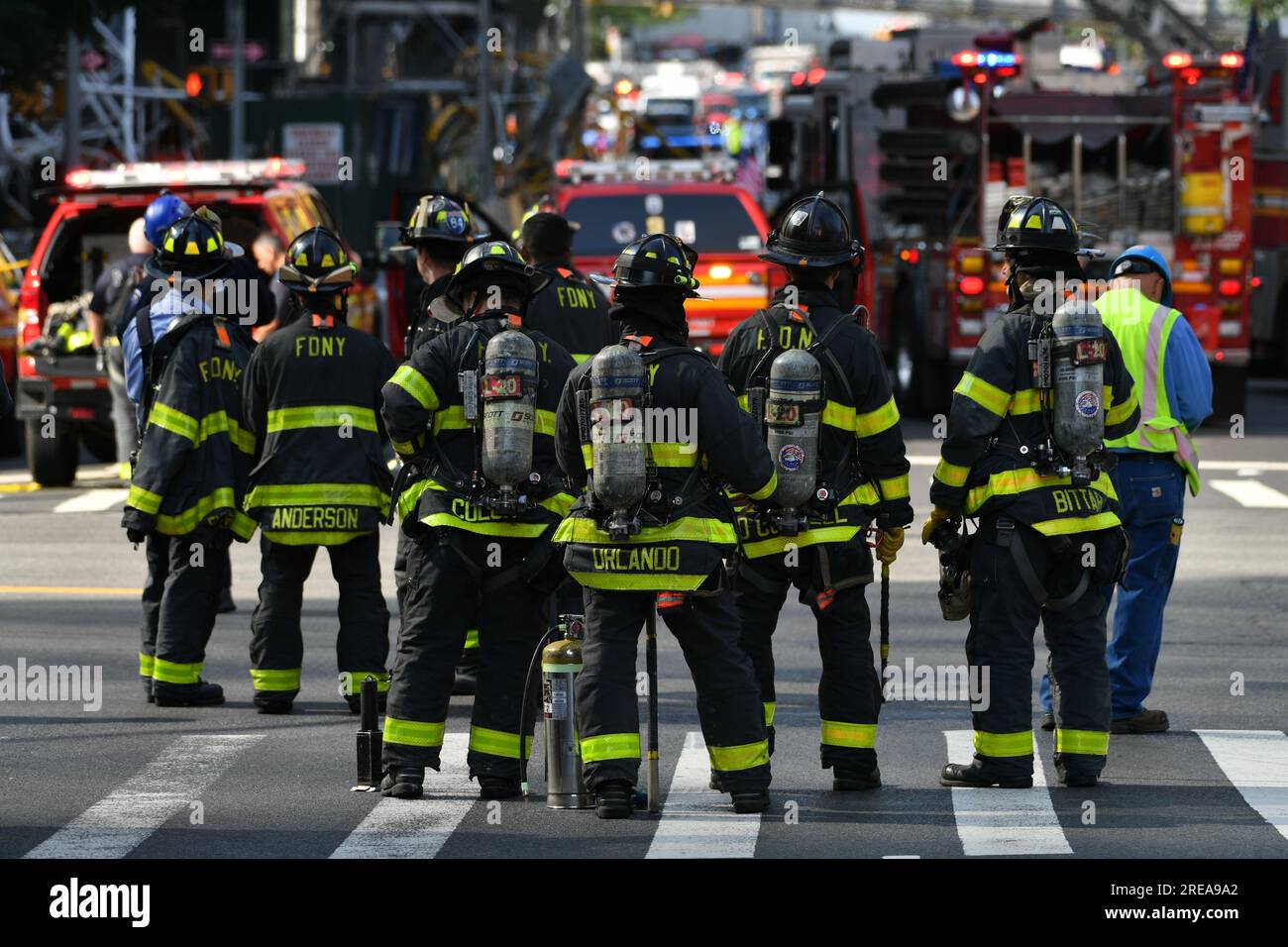 Debris from a crane collapse sit in the road as police, firefighters and emergency personnel gather at the scene in midtown Manhattan on July 26, 2023 Stock Photo