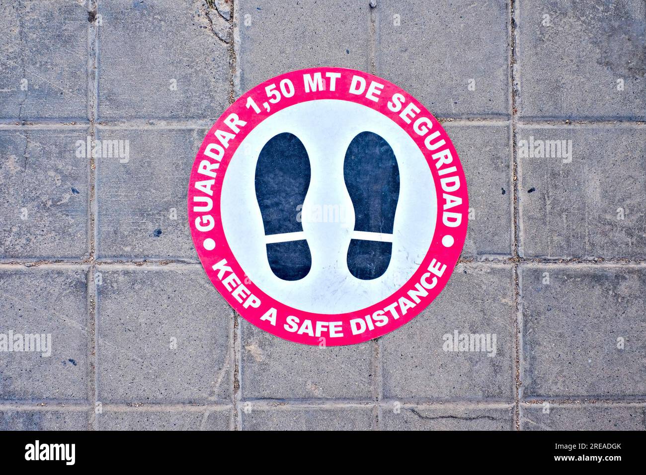 Covid-19 safe distance sign in Spanish and English (Spanish text: guardar 1.5m de seguridad, English translation: keep safe distance of 1.5 meter). Stock Photo