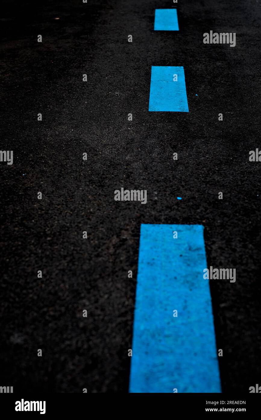 Offset dashed blue road marking line painted on black pavement surface Stock Photo Alamy