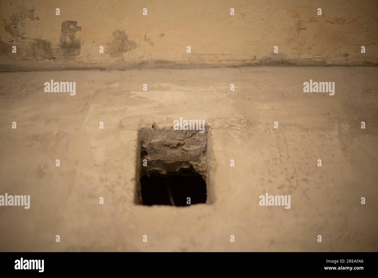 Hole in wall. Home repair. Concrete surface. Ventilation in apartment