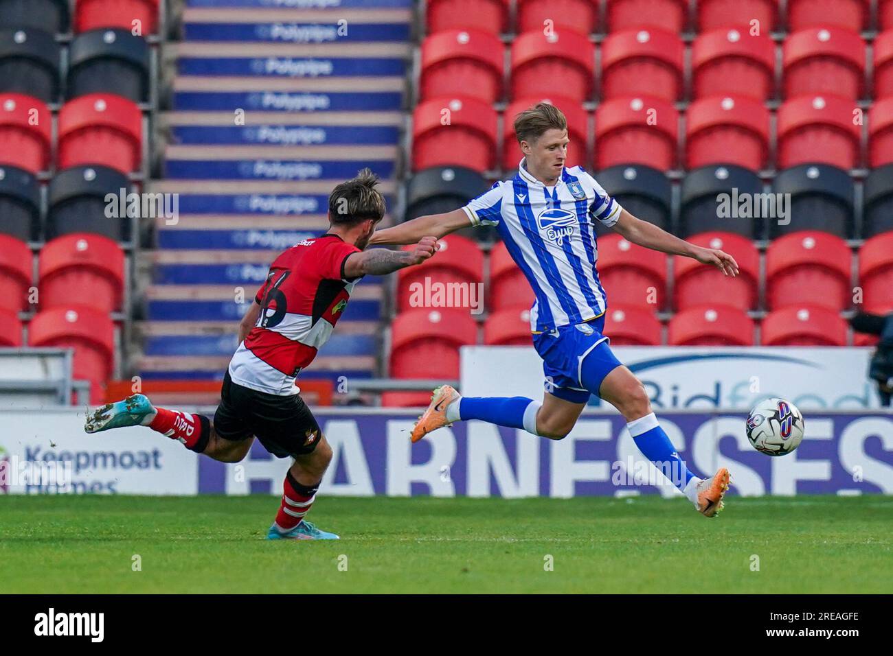 Doncaster, UK. 25th July, 2023. Sheffield Wednesday George Byers and Doncaster Rovers Tom Nixon during the Doncaster Rovers FC vs Sheffield Wednesday FC Pre-Season match at Eco-Power Stadium, Doncaster, United Kingdom on 25 July 2023 Credit: Every Second Media/Alamy Live News Stock Photo