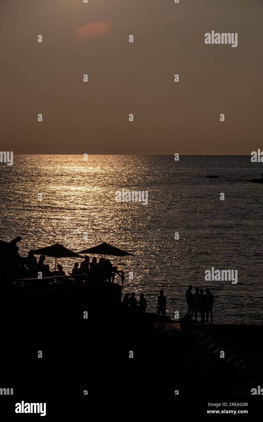 Image of a sunset with a cocktail bar with the infinite sea. Stock Photo