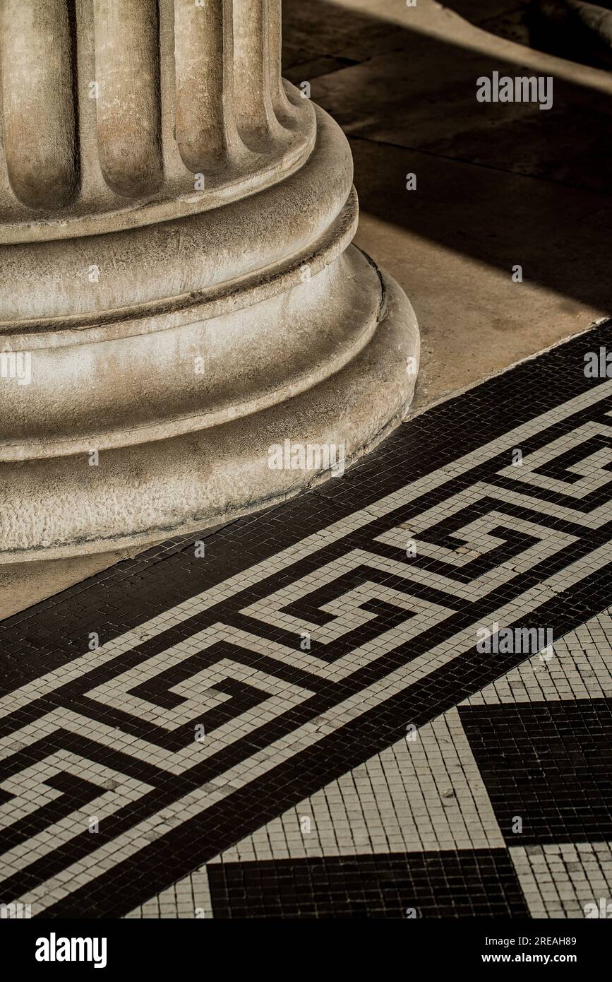Classical ancient Roman or Greek style architectural support column and tiled flooring detail. Stock Photo