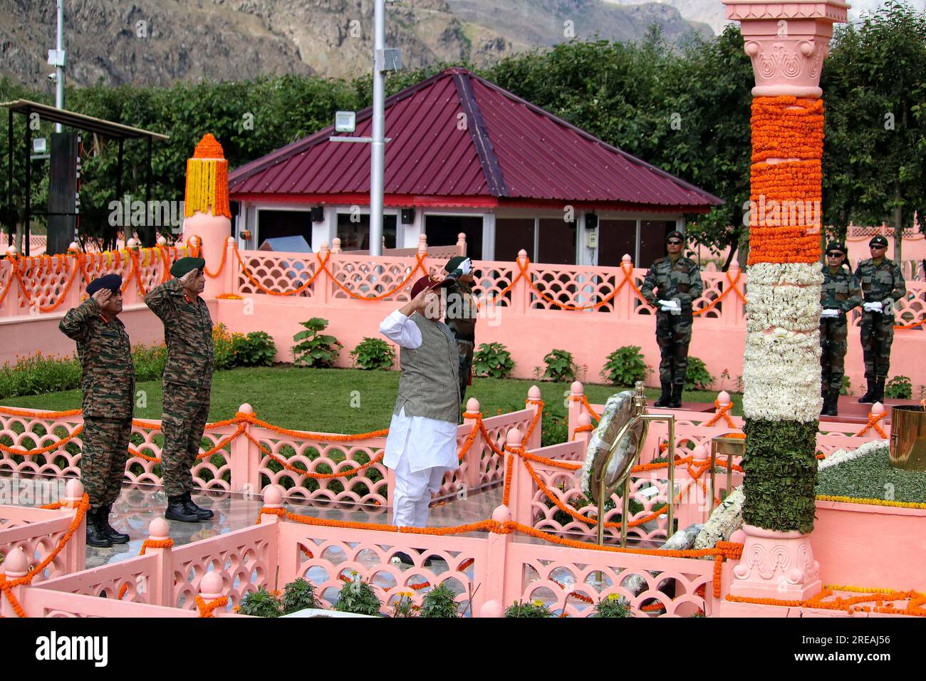 July 26, 2023, Drass Kashmir, India : Indian Union Defence Minister Rajnath Singh and senior Army officer salute as they pay tribute at war memorial during 'Vijay Diwas' or victory day celebration in Drass, 160 km (99 miles) east of Srinagar. The Indian army commemorates 'Vijay Diwas' annually in memory of more than 500 soldiers who were killed eleven years ago during a war with Pakistan. The war took place in the mountains of the Kargil and Drass sectors, at the Line of Control or a military ceasefire line, which divided Kashmir between the two south Asian rivals. On July 26, 2023 in Drass Ka Stock Photo