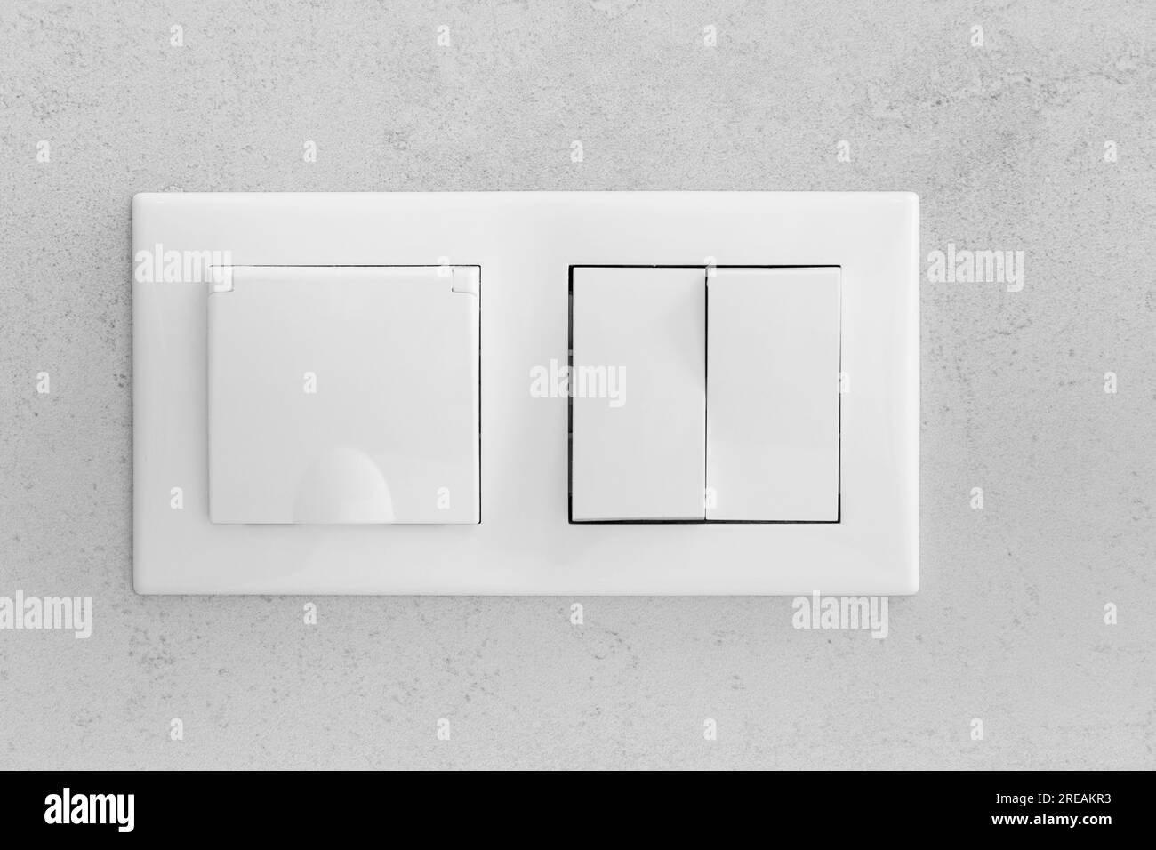 Closed socket and switch on porcelain stoneware in the bathroom Stock Photo