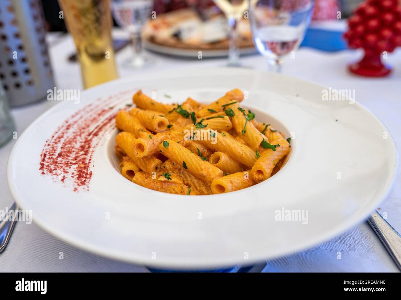 Rigatoni Francescana served at a beachfront restaurant in Cefalù along Lungomare Giuseppe Giardina. Stock Photo