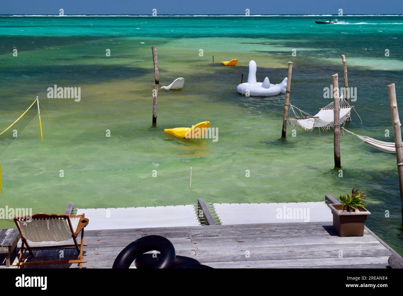 Hammocks and pool floats over the Caribbean Sea, within the Belize