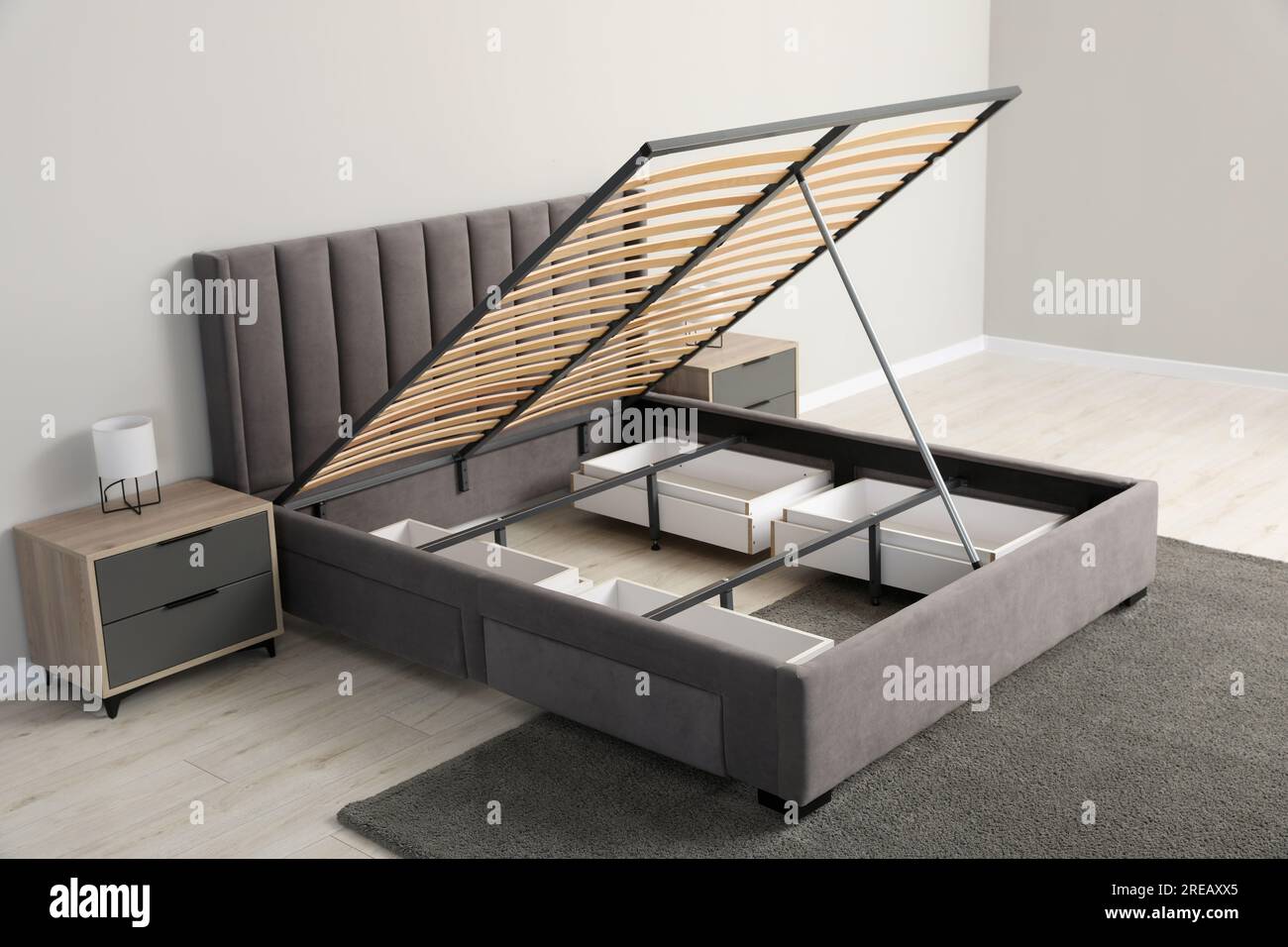 Comfortable bed with storage space for bedding under lifted slatted