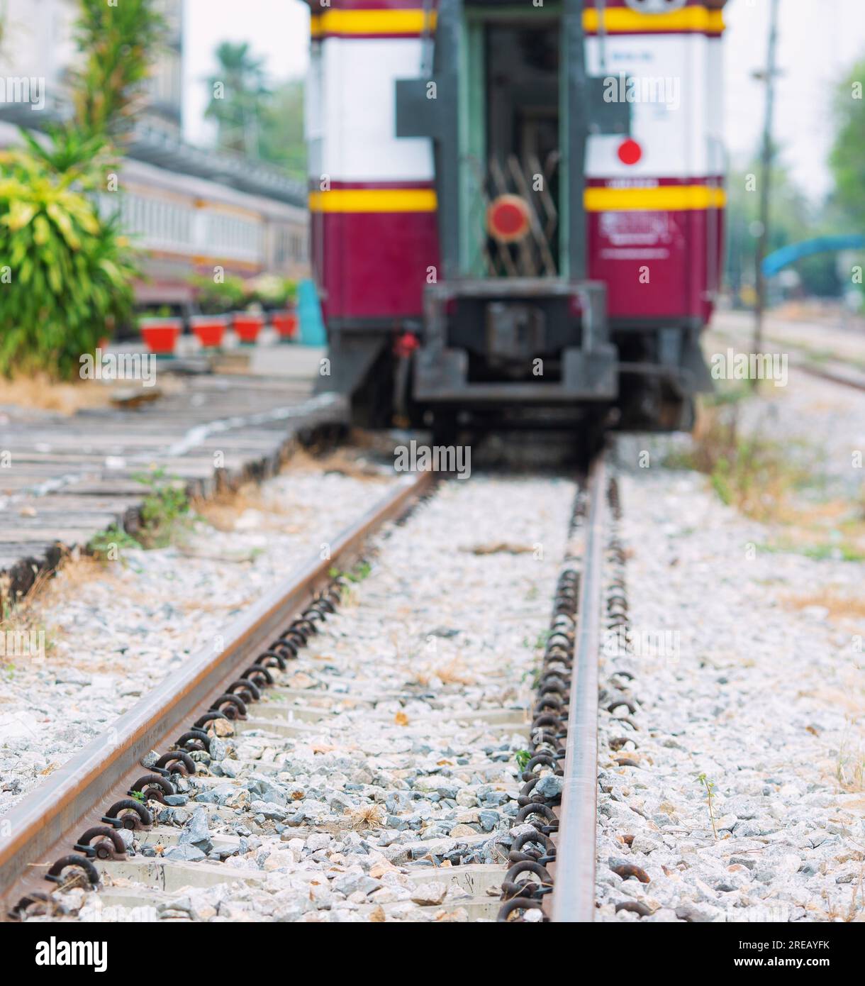 A lowangle photograph of a train track in the background showing a