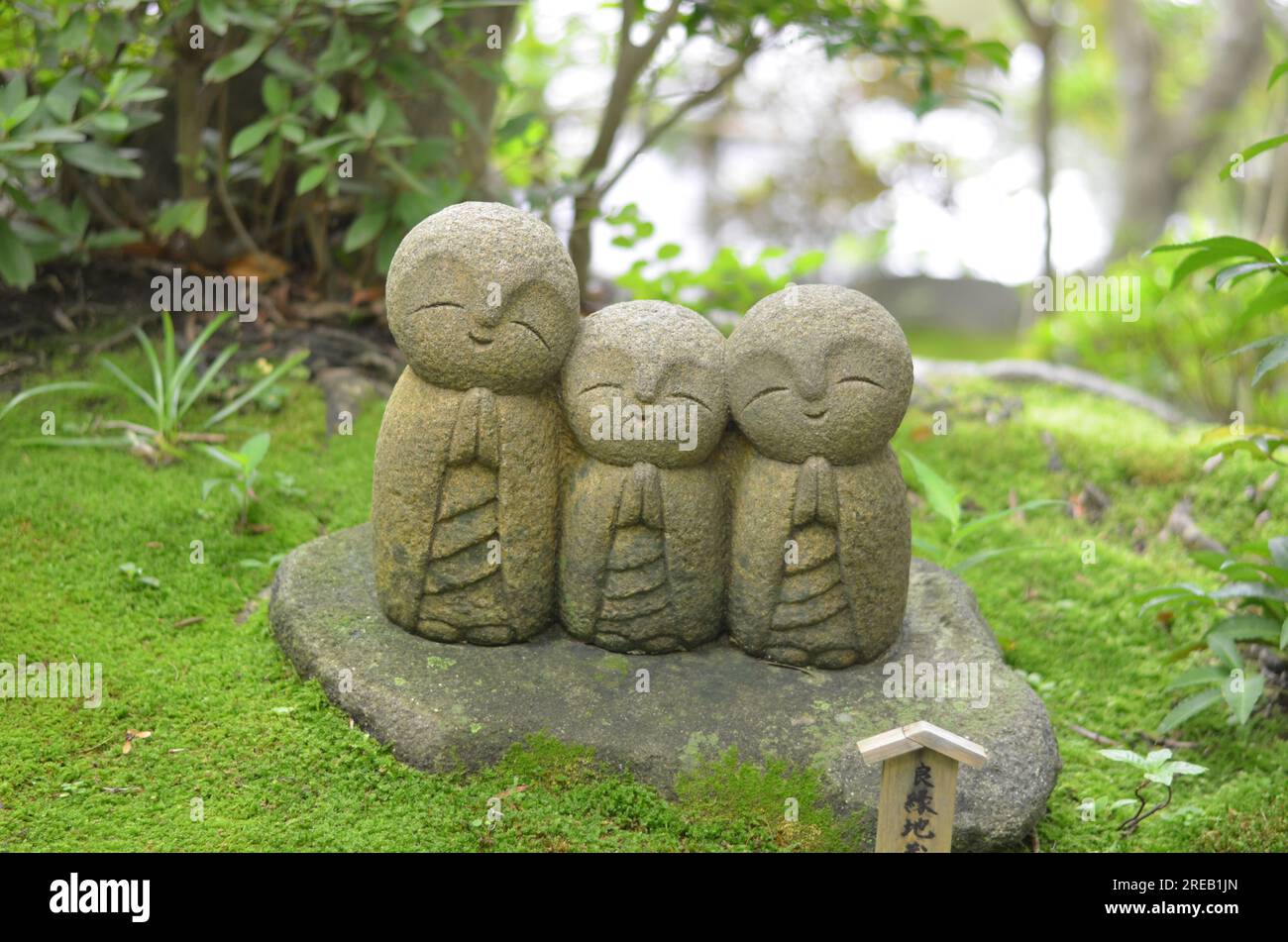 Cute Ryoen Jizo statues at Kamakura Haedera temple in Japan with a green summer background Stock