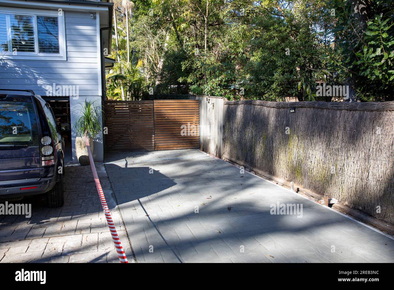 Australia, new concrete driveway poured at side of an Australian home in Sydney, concrete is drying and is taped off Stock Photo