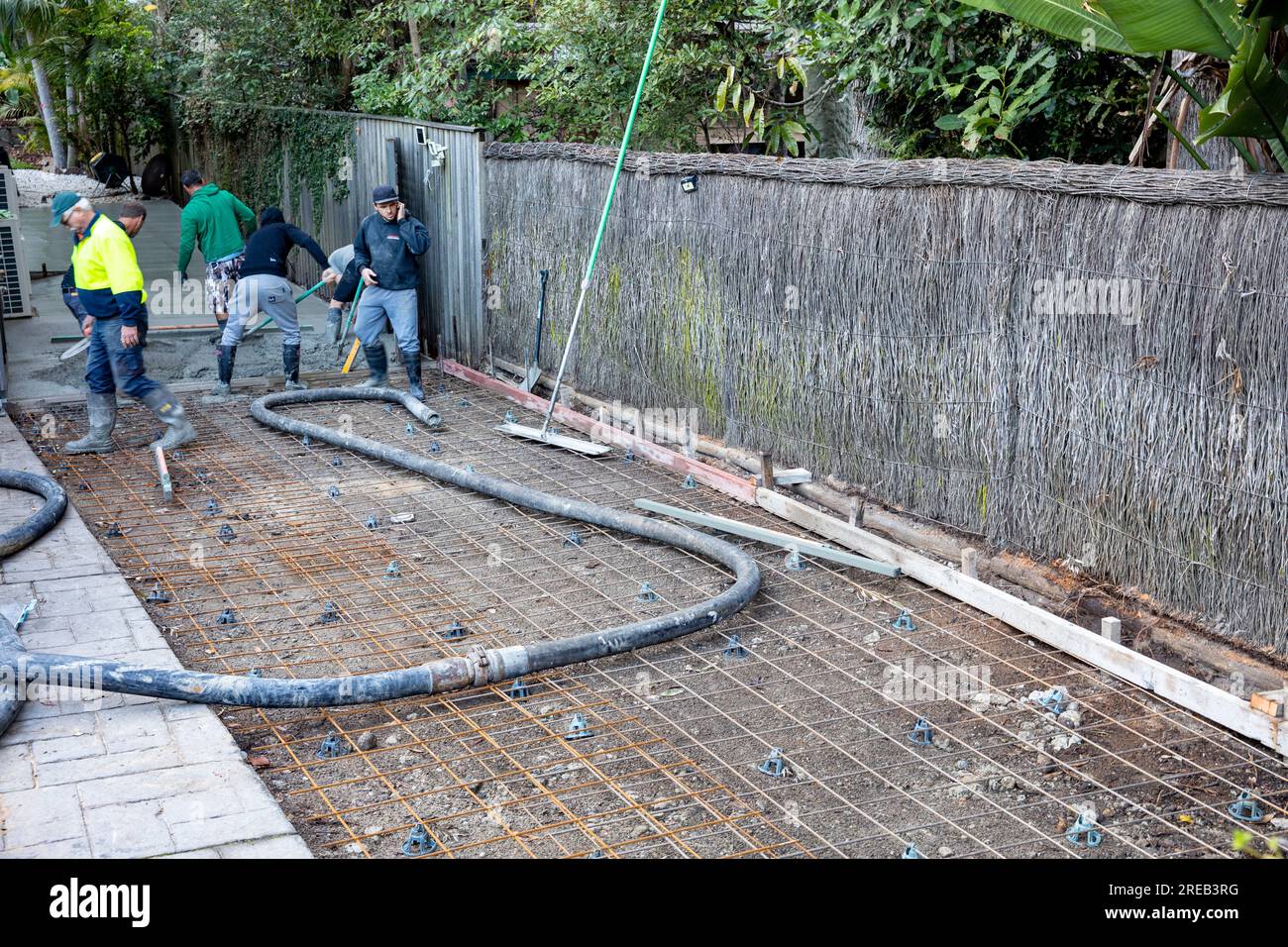 Builders pour concrete to lay new driveway at the side of an Australian