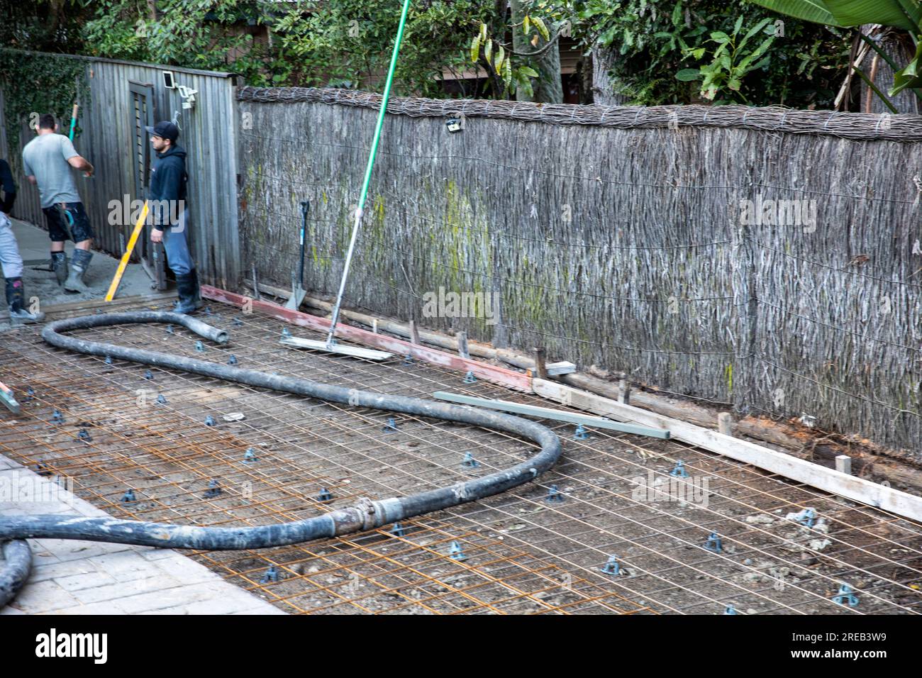 Builders pour concrete to lay new driveway at the side of an Australian home in Sydney,NSW,Australia Stock Photo