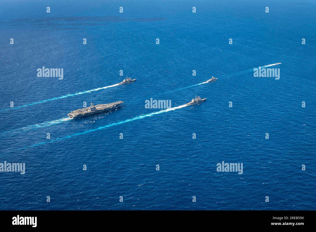 INDIAN OCEAN (July 22, 2023) The U.S. Navy’s only forward-deployed aircraft carrier, USS Ronald Reagan (CVN 76), steams in formation with the Royal Australian Navy ship HMAS Perth (FFH 157), as well as the Virginia-class fast-attack submarine USS North Carolina (SSN 777) and Ticonderoga-class guided-missile cruisers USS Robert Smalls (CG 62) and USS Antietam (CG 54), during Talisman Sabre 23 in the Indian Ocean, July 22, 2023.                Ronald Reagan, the flagship of Carrier Strike Group 5, provides a combat-ready force that protects and defends the United States, and supports alliances, Stock Photo