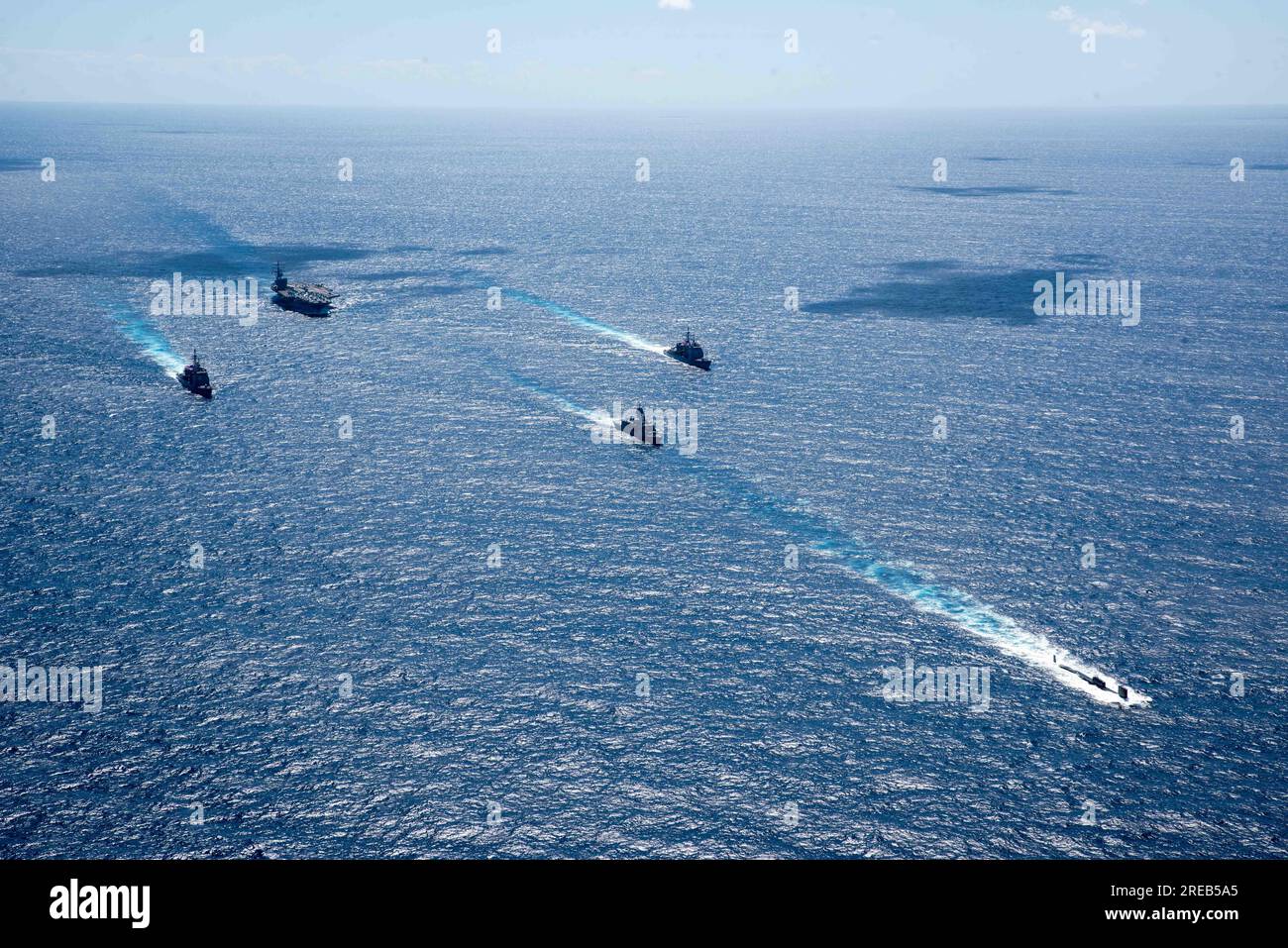 INDIAN OCEAN (July 22, 2023) The U.S. Navy’s only forward-deployed aircraft carrier, USS Ronald Reagan (CVN 76), steams in formation with the Royal Australian Navy ship HMAS Perth (FFH 157), as well as the Virginia-class fast-attack submarine USS North Carolina (SSN 777) and Ticonderoga-class guided-missile cruisers USS Robert Smalls (CG 62) and USS Antietam (CG 54), during Talisman Sabre 23 in the Indian Ocean, July 22, 2023.      Ronald Reagan, the flagship of Carrier Strike Group 5, provides a combat-ready force that protects and defends the United States, and supports alliances, partnershi Stock Photo