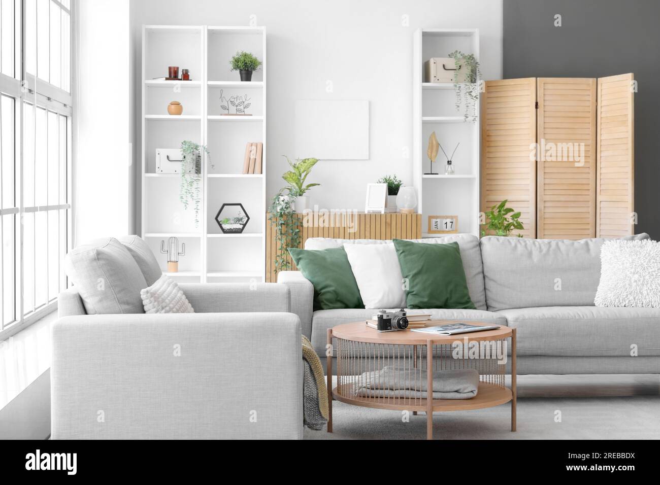 Interior of bright living room with cozy grey sofas and coffee table ...