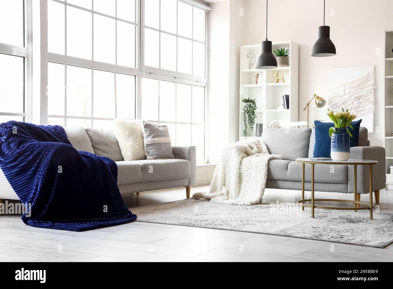 Interior of bright living room with cozy sofas and coffee table near ...