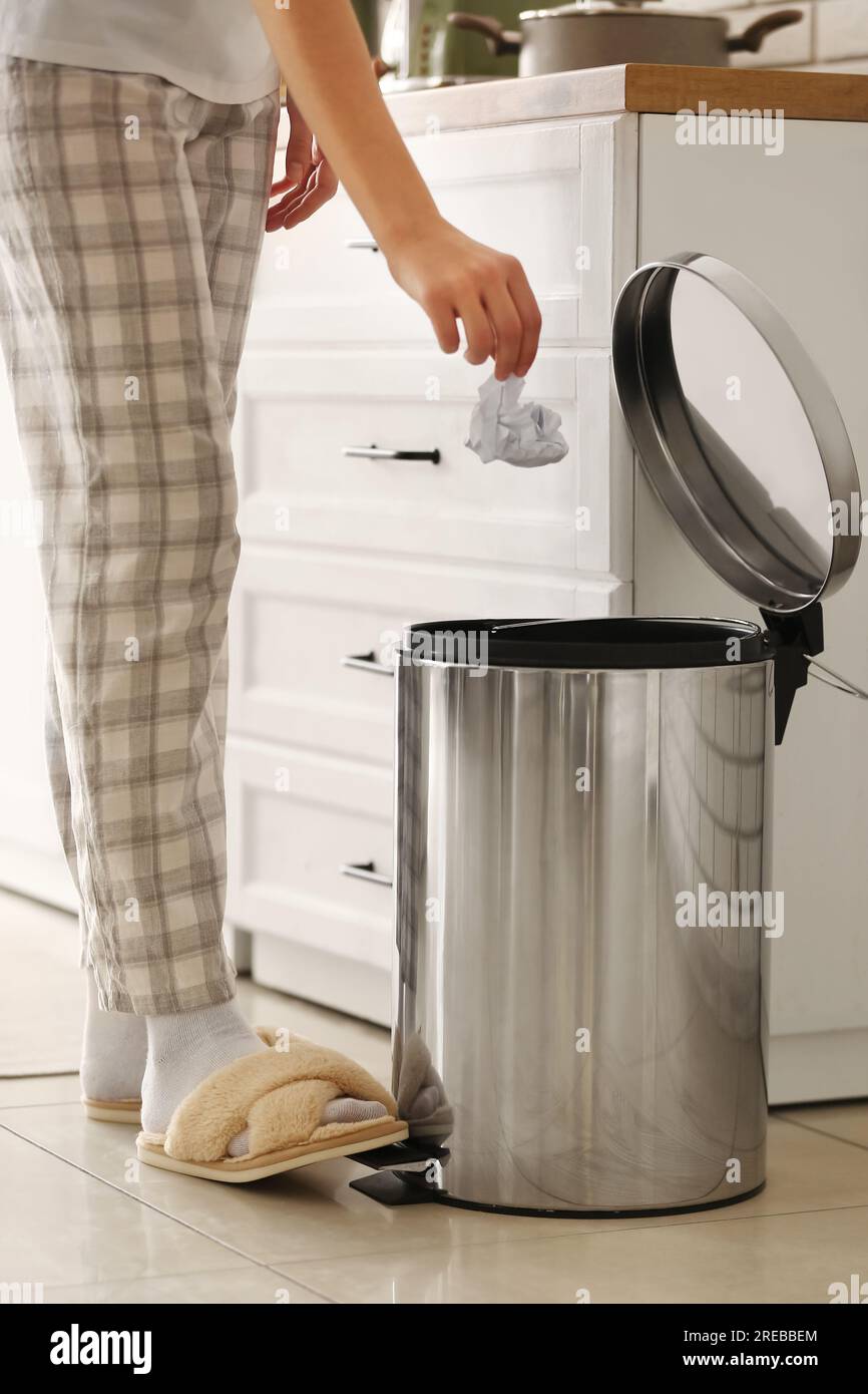 Woman throwing rubbish into trash bin in modern kitchen Stock Photo Alamy